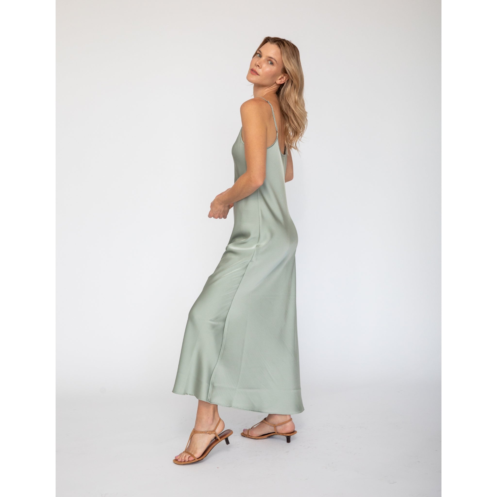Model wearing Quyenn Erika Solid Sage Green Slip Dress with minimalist silhouette and adjustable straps